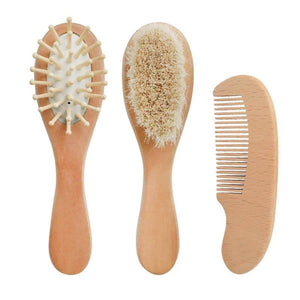 Feather & Fawn 3-piece baby grooming set with natural lotus wood brush, sheep wool bristles, wooden comb, and linen storage bag.
