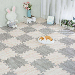 BabiePlay Wood Grain Play Mat EVA foam puzzle mat soft safe non-slip baby exercise gym floor mat with wood grain design and pet resting on it