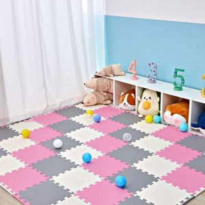 Pink Collection Foam Mats interlocking baby play mats in pink, gray, and white with soft cushioning and playful balls scattered on top in a nursery setting