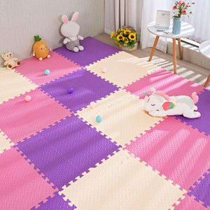 Interlocking baby foam play mats in pink, purple, and cream colors with toys on a nursery floor