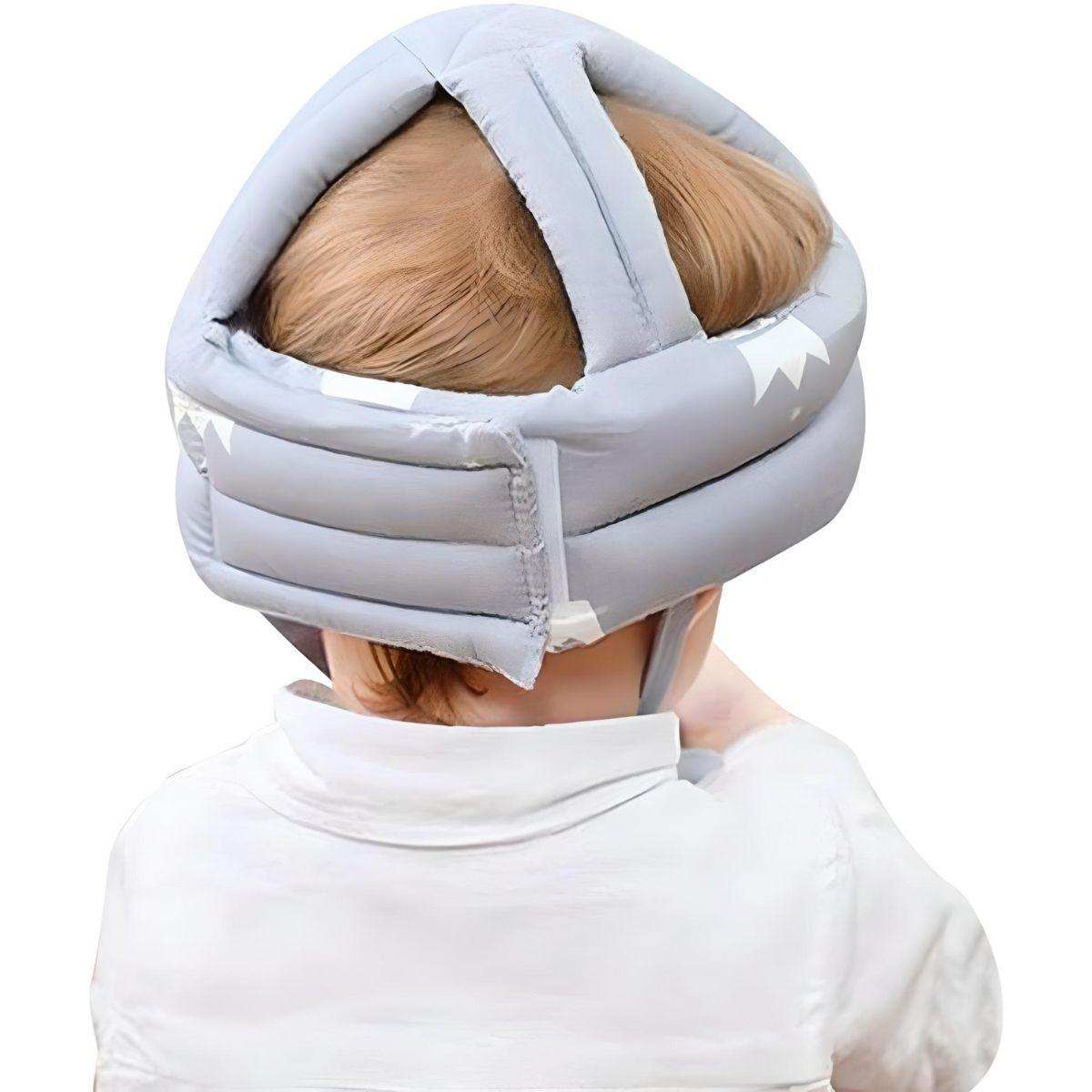 Baby wearing Feather & Fawn ProtectCap adjustable grey safety helmet for head protection during play