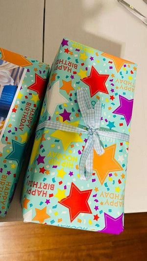 Colorful birthday gift wrapped with star-patterned paper and tied with a blue checkered ribbon for gift wrap