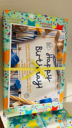 Colorful birthday gift wrapped with star-patterned paper and yellow ribbon