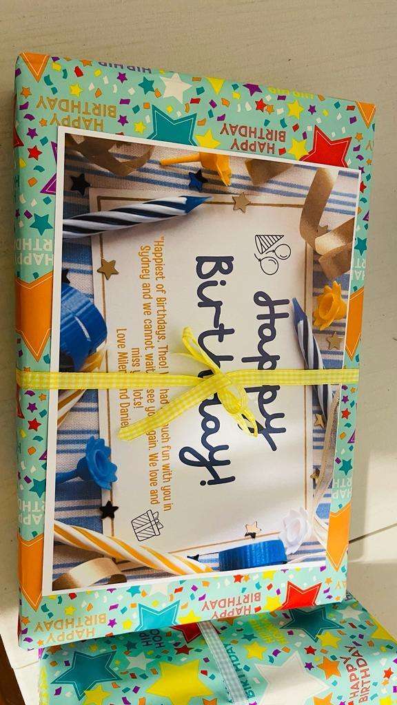 Colorful birthday gift wrapped with star-patterned paper and yellow ribbon
