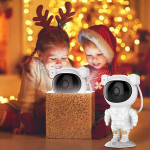 Children enjoying Glowly Astronaut LED galaxy projector with Christmas lights background