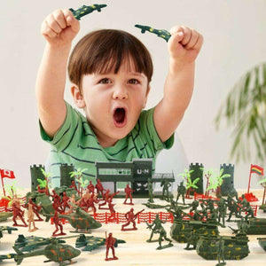 Excited boy playing with Kidst 307PCS Military Toy Playset featuring detailed plastic soldiers and vehicles on a table.