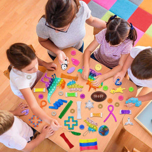 Kids and adult playing with colorful Kidst Fidget Sensory Toy Set on table for stress relief and focus