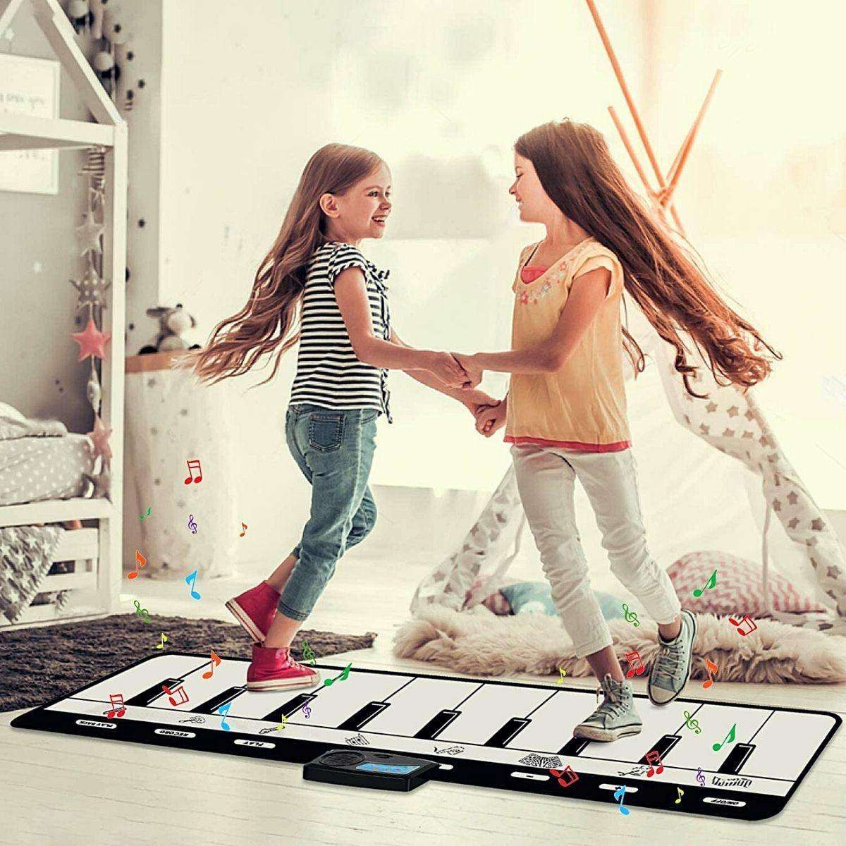 Two girls playing and dancing on Kidst Piano Play Mat musical keyboard dance mat in a bright room