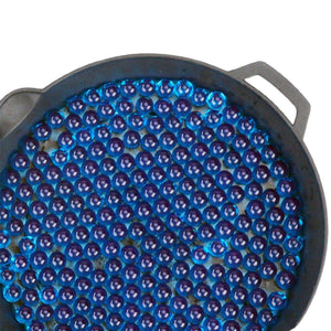 Tray filled with numerous blue marbles or beads