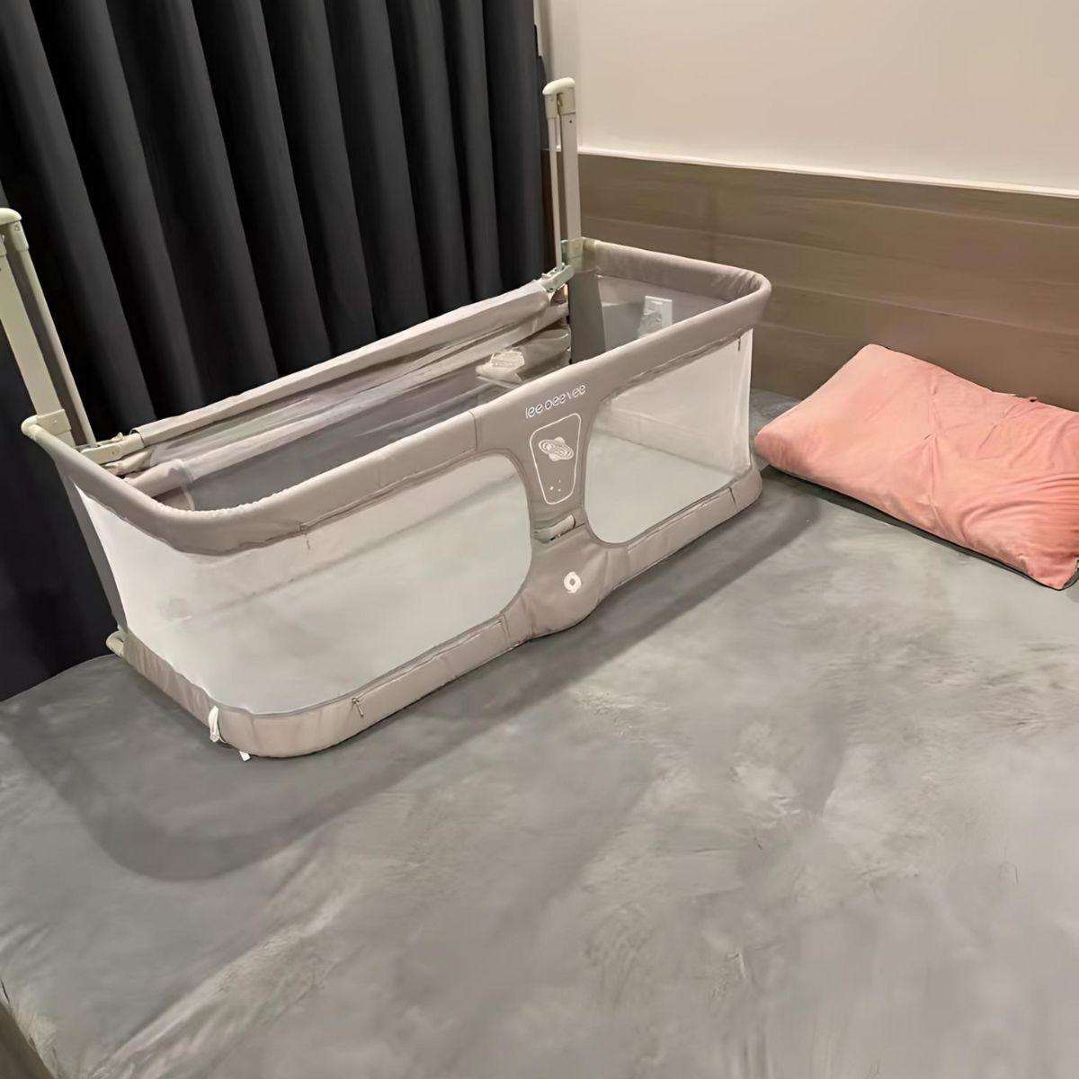 Toddly NightNest adjustable bedside bed rail with breathable mesh for baby safety on a bed