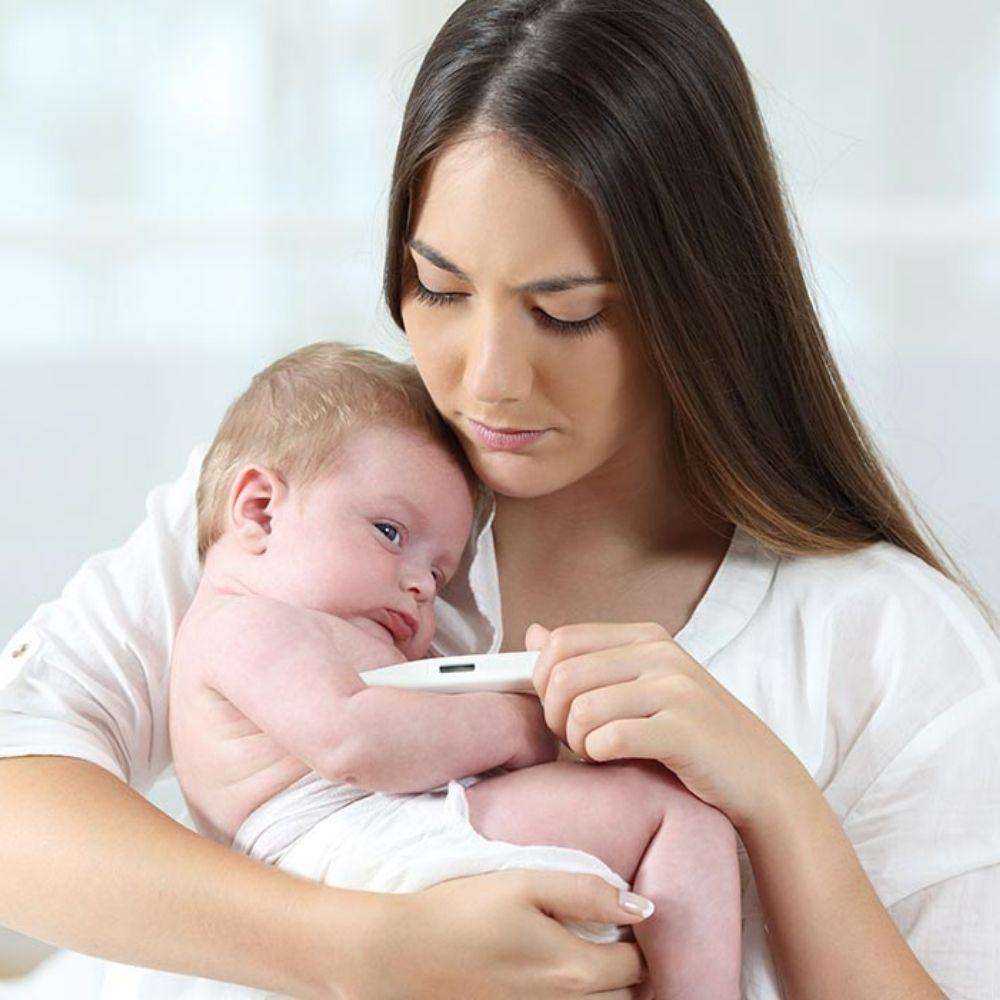 Mother washing baby's hands to prevent cold