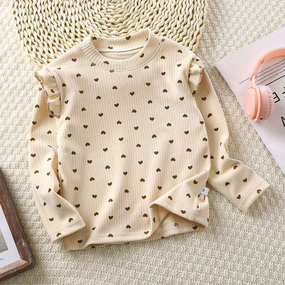 Toddler wearing Feather & Fawn ribbed ruffle long sleeve top