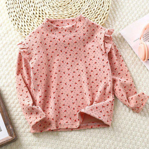 Toddler wearing Feather & Fawn ribbed ruffle long sleeve top in winter print