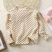Toddler wearing Feather & Fawn ribbed ruffle long sleeve top