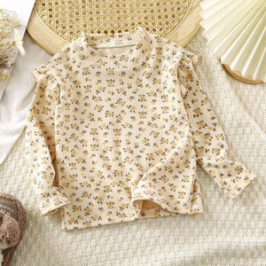 Toddler wearing Feather & Fawn ribbed ruffle long sleeve top