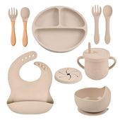 Toddly MealMate 10-piece silicone feeding set with suction plate, bowls, wooden utensils, and cups for baby-led weaning and self-feeding