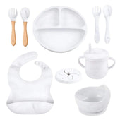 Toddly MealMate 10-piece silicone feeding set with bib, suction plate, bowls, wooden and bear utensils for baby-led weaning and self-feeding.