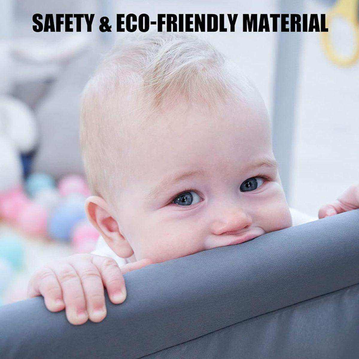 Baby chewing on Toddly Explorer Max baby playpen rail in safe play area